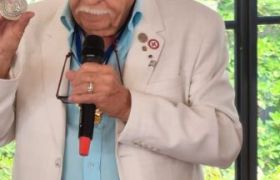 Le Président Anastile présente la médaille  avant la remise